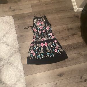 Black dress with lots of colorful deeding